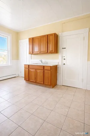 a view of a kitchen with microwave and cabinets