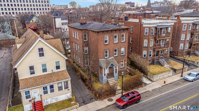a front view of a residential apartment building with a yard