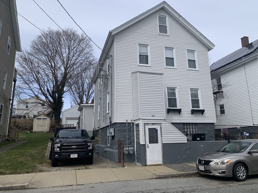 149 Smith Street Fall River, MA 02721 - Photo 1 of 38 a car parked in front of a white house