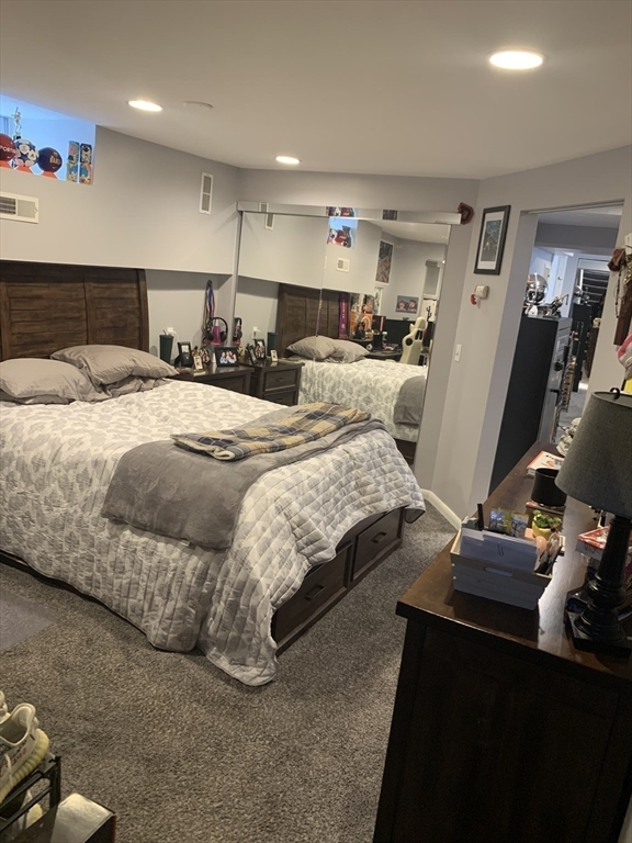 149 Smith Street Fall River, MA 02721 - Photo 21 of 38 a bedroom with a bed and a gym machine