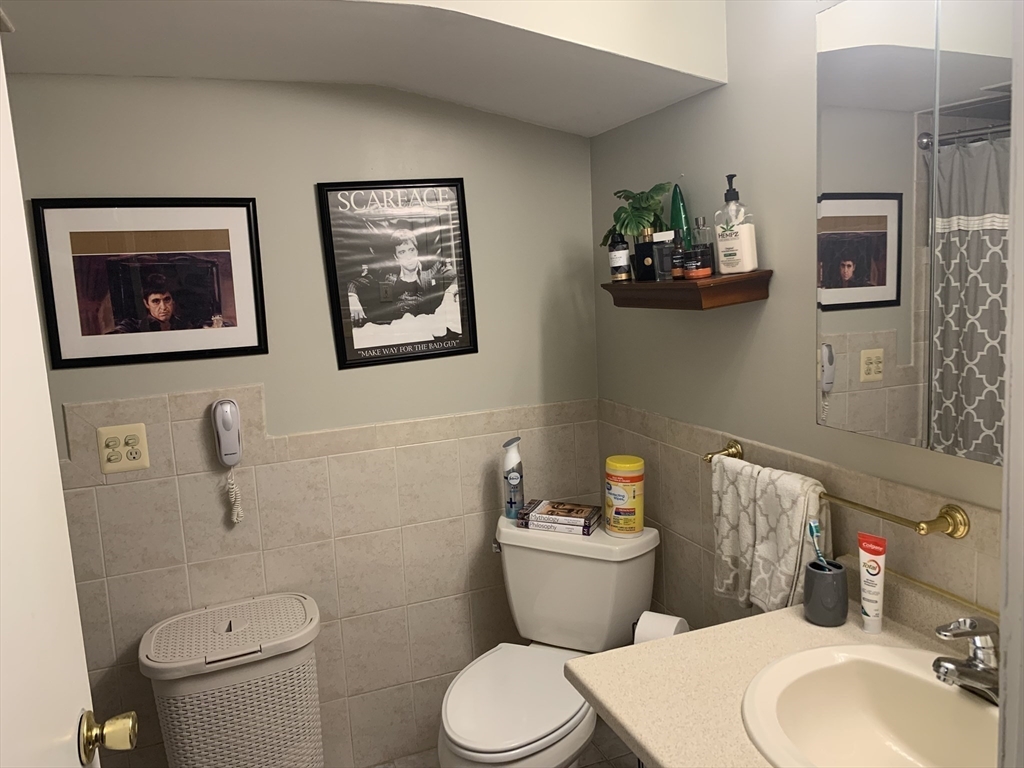 149 Smith Street Fall River, MA 02721 - Photo 23 of 38 a white toilet sitting next to a bathroom sink
