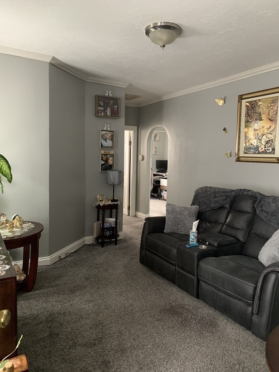 149 Smith Street Fall River, MA 02721 - Photo 24 of 38 a living room with furniture and a gym equipment