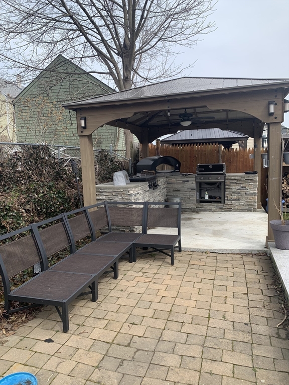 149 Smith Street Fall River, MA 02721 - Photo 4 of 38 a view of a chairs and fire pit in the patio