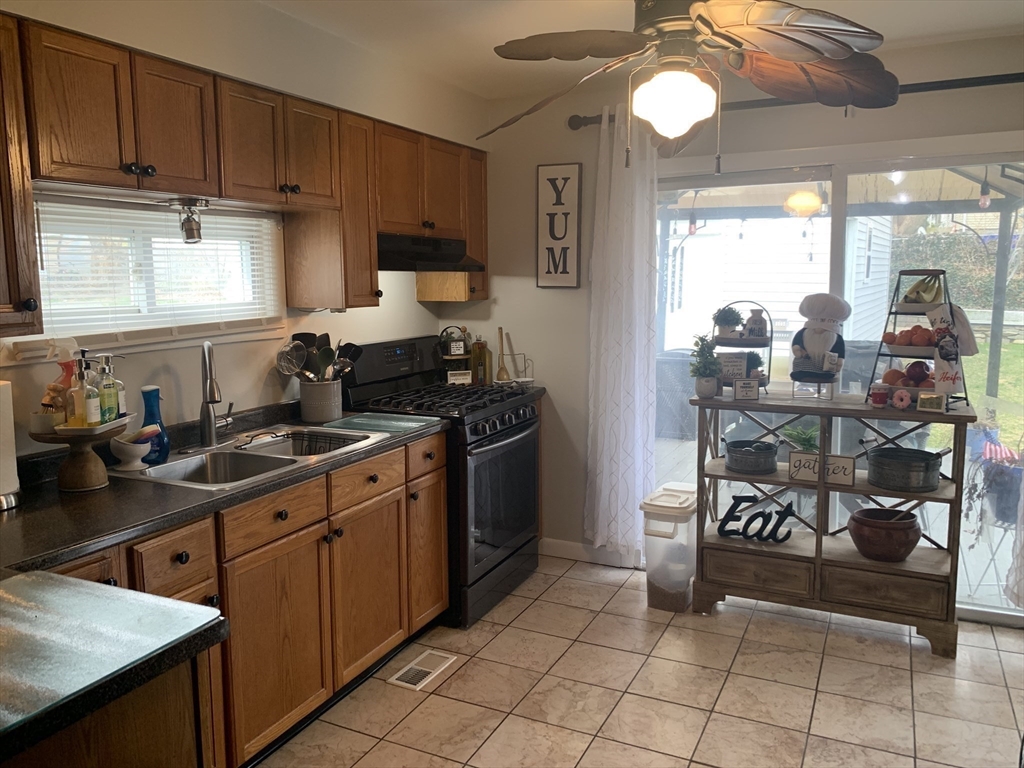149 Smith Street Fall River, MA 02721 - Photo 7 of 38 a kitchen with stainless steel appliances granite countertop a stove a sink and a refrigerator