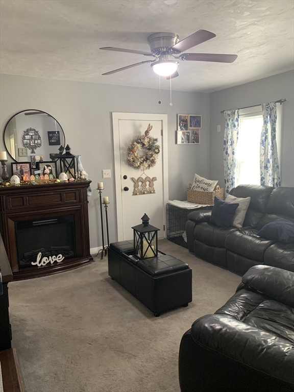149 Smith Street Fall River, MA 02721 - Photo 10 of 38 a living room with furniture a fireplace and a window