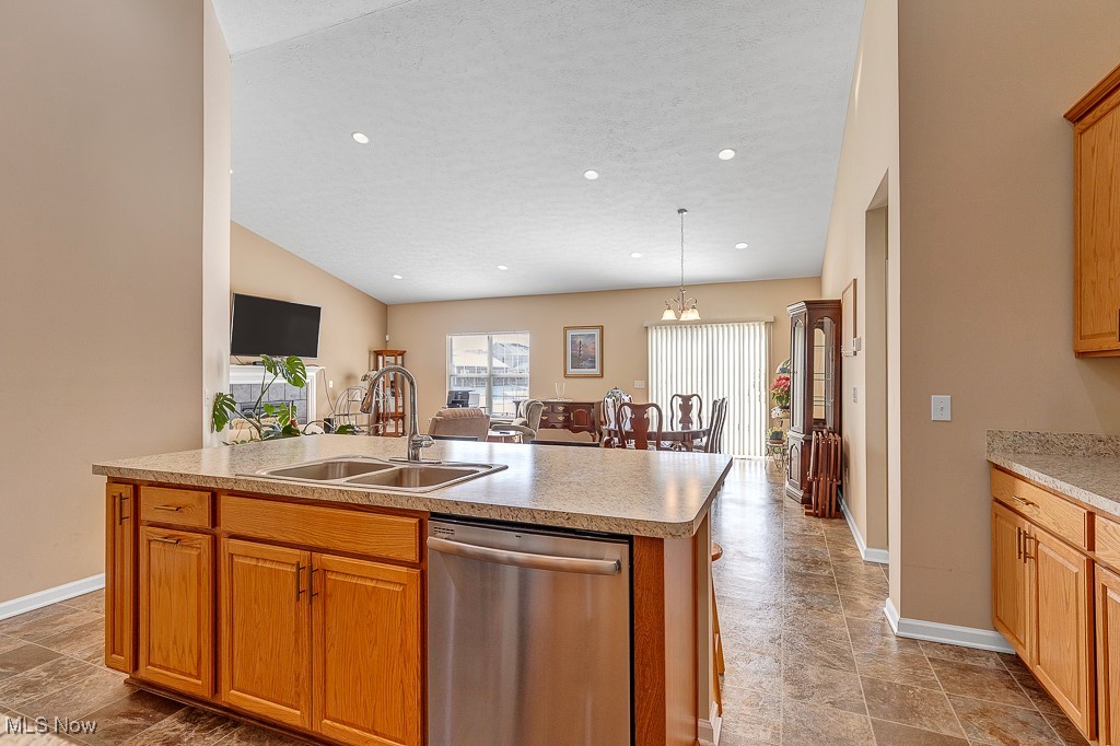 37289 Sandy Ridge Drive North Ridgeville, OH 44039 - Photo 6 of 21 Kitchen with a notable chandelier, pendant lighting, stainless steel dishwasher, sink, and a kitchen island with sink