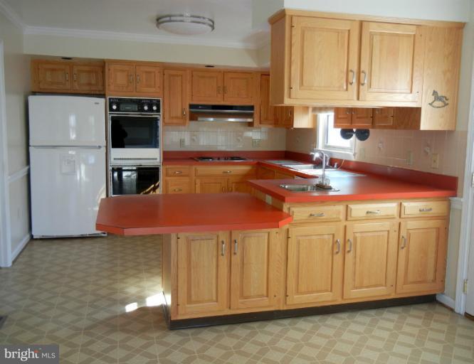8413 Riverside Road Alexandria, VA 22308 - Photo 14 of 28 a kitchen with stainless steel appliances granite countertop a sink a stove and cabinets