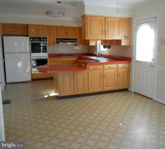 8413 Riverside Road Alexandria, VA 22308 - Photo 21 of 28 a kitchen with kitchen island granite countertop a stove top oven a sink a counter space and cabinets