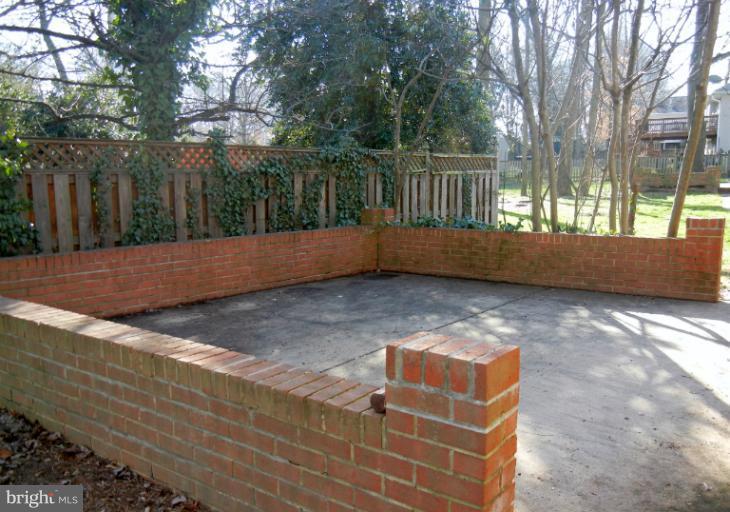 8413 Riverside Road Alexandria, VA 22308 - Photo 8 of 28 a backyard of a house with large trees and outdoor seating
