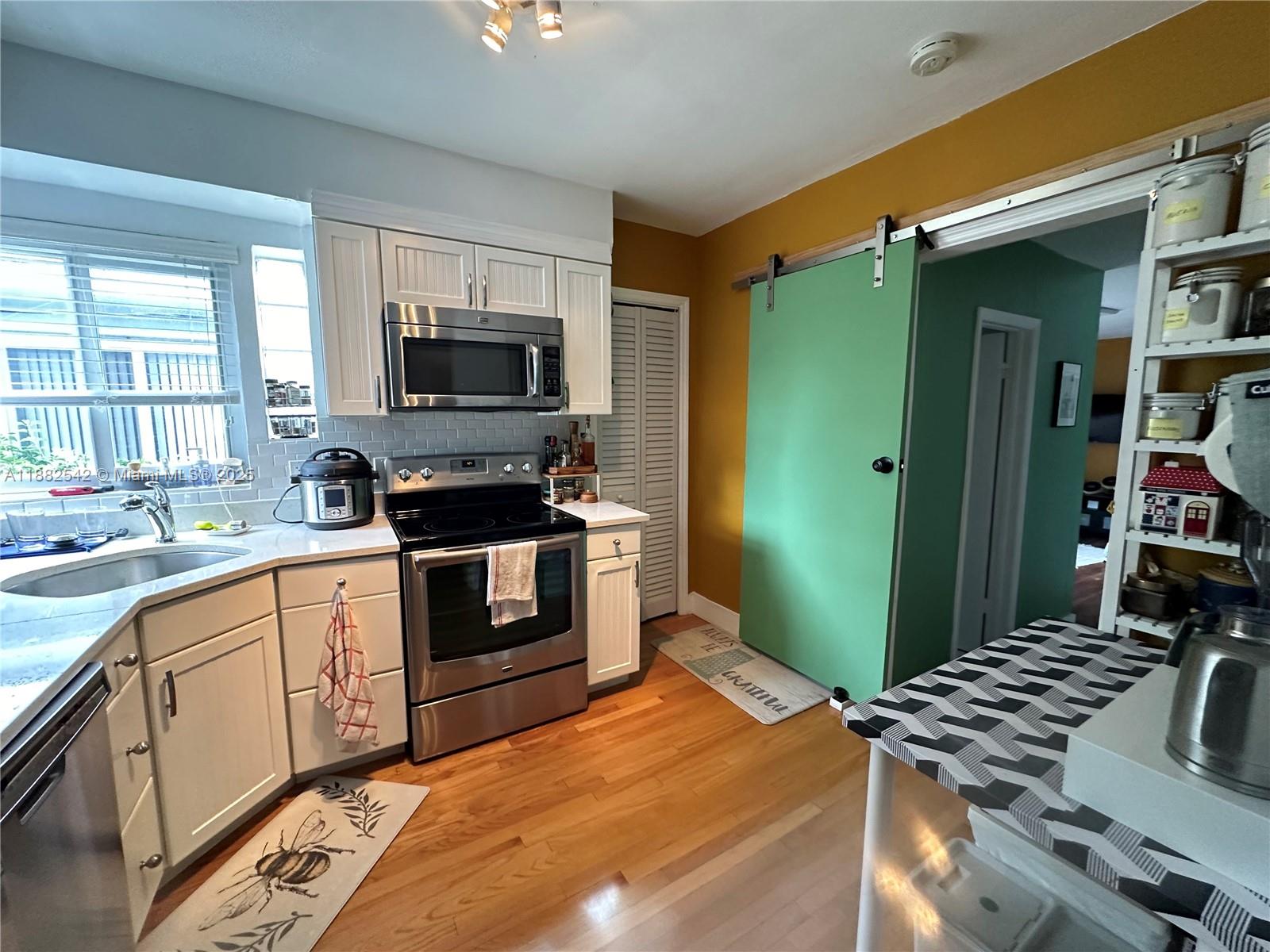 2270 Southwest 24th Street Miami, FL 33145 - Photo 11 of 28 a kitchen with stainless steel appliances granite countertop a stove and a sink