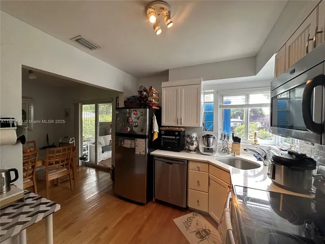 a kitchen with a sink appliances and cabinets
