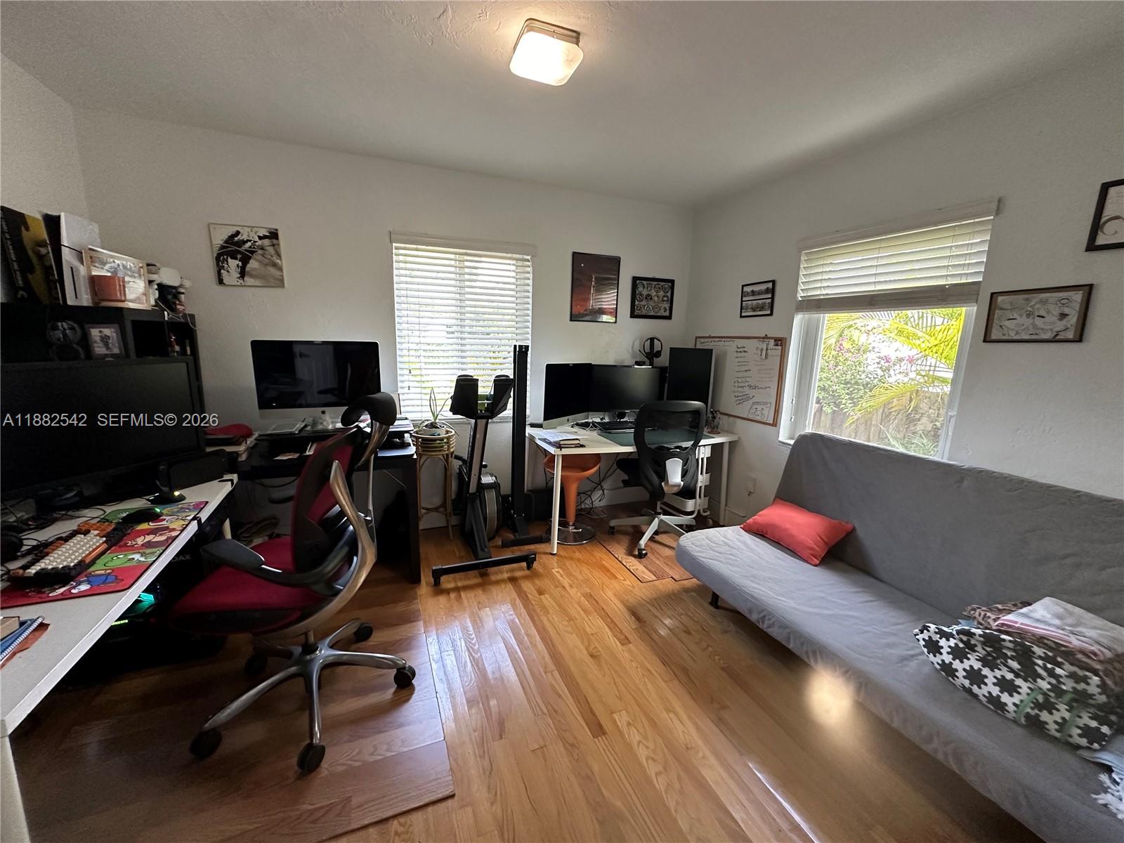 2270 Southwest 24th Street Miami, FL 33145 - Photo 16 of 35 a living room with furniture gym equipment and a flat screen tv