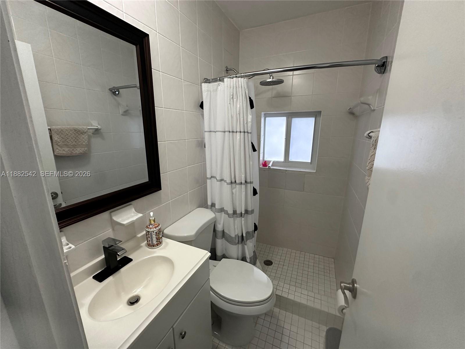 2270 Southwest 24th Street Miami, FL 33145 - Photo 17 of 35 a bathroom with a sink toilet and shower