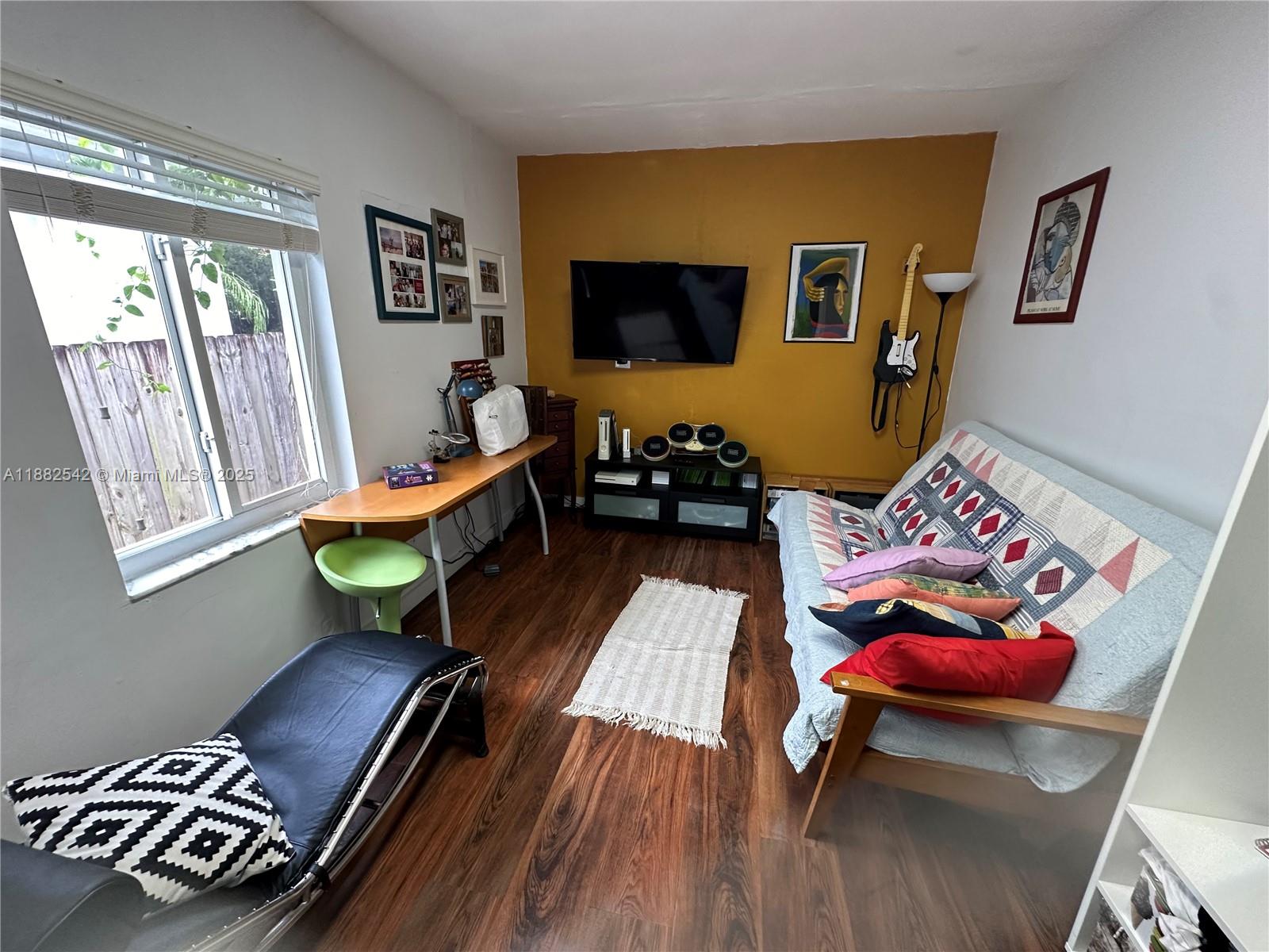 2270 Southwest 24th Street Miami, FL 33145 - Photo 19 of 28 a living room with furniture and a flat screen tv
