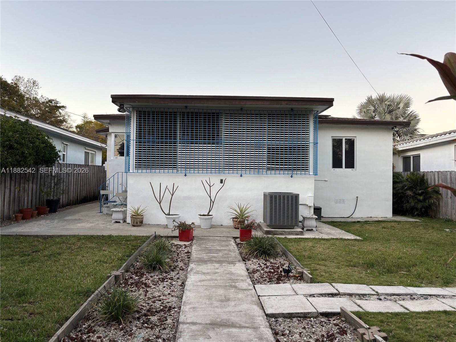 2270 Southwest 24th Street Miami, FL 33145 - Photo 21 of 35 a front view of a house with a yard