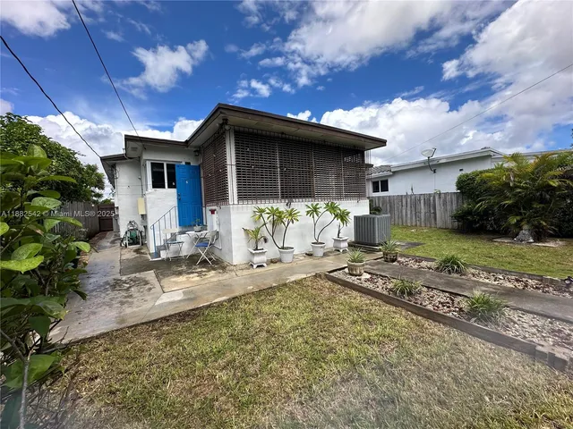 a view of a patio with table and chairs potted plants with wooden floor
