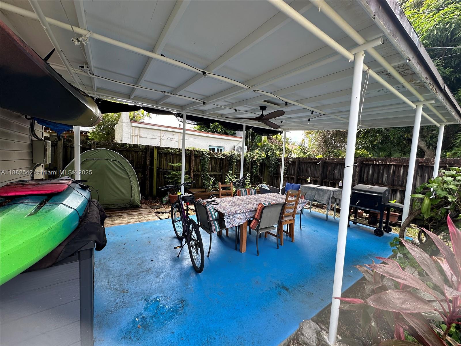 2270 Southwest 24th Street Miami, FL 33145 - Photo 24 of 28 a view of a patio with table and chairs potted plants with wooden floor