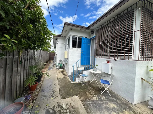 a view of backyard with outdoor seating and green space