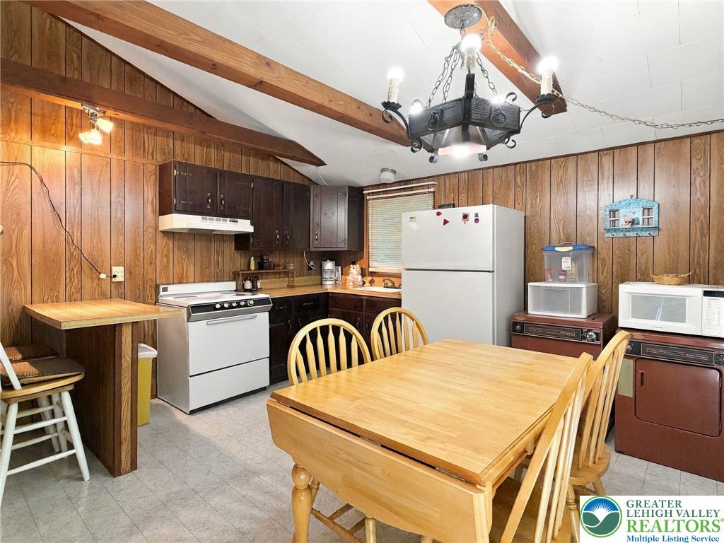 116 Aspen Road Albrightsville, PA 18210 - Photo 25 of 33 Exposed wood beams and matching wall paneling bring rustic warmth to this functional kitchen.
