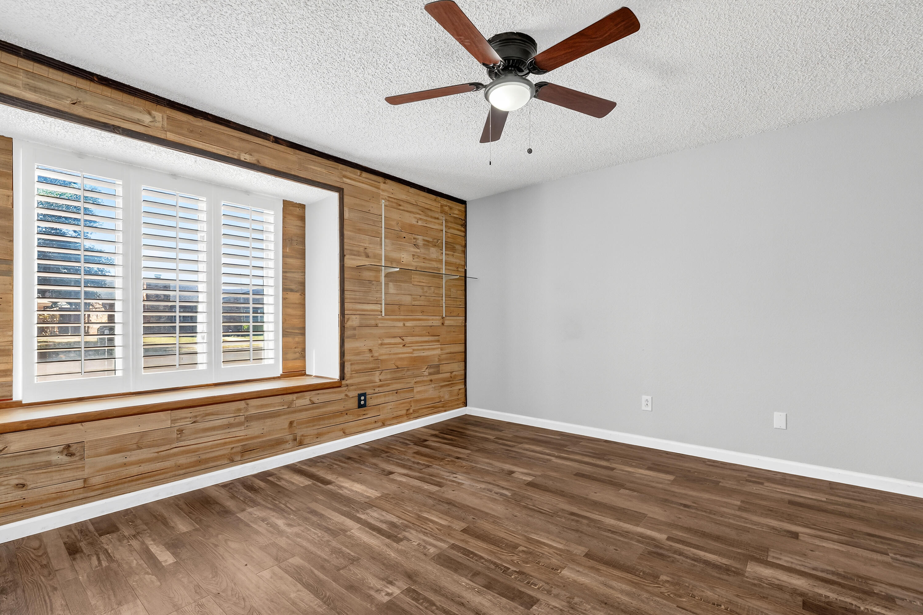 5236 91st Street Lubbock, TX 79424 - Photo 18 of 23 an empty room with wooden floor and windows