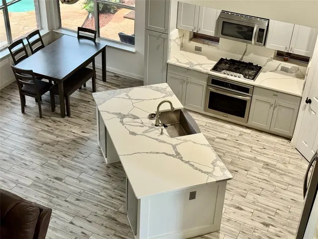 a kitchen with a sink appliances and cabinets
