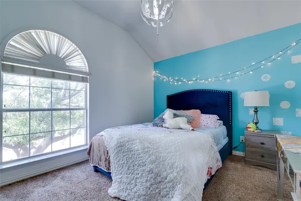 a bedroom with a large bed and a large window