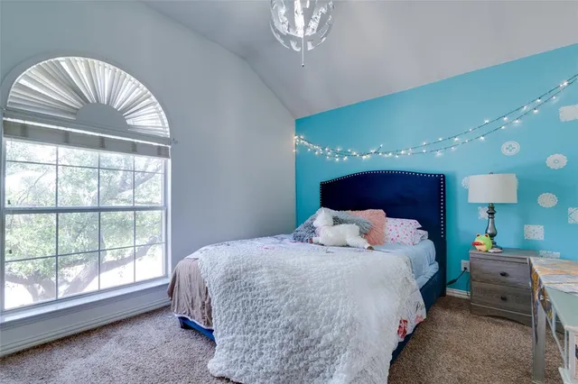 a bedroom with a large bed and a large window