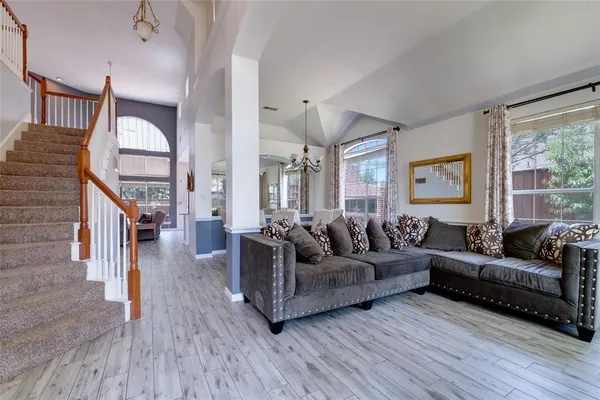 a living room with furniture or wooden floor and a large window