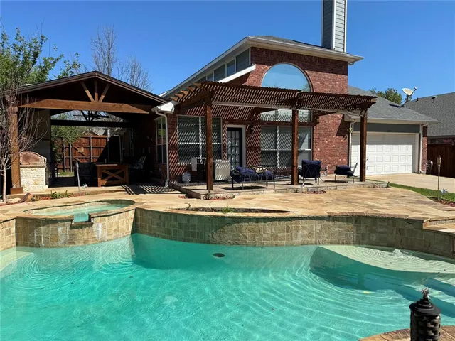 a view of a house with swimming pool and sitting area