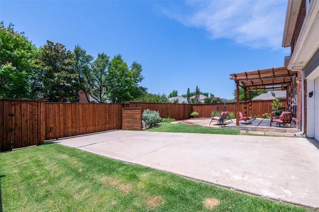 a view of a chair and table in the back yard