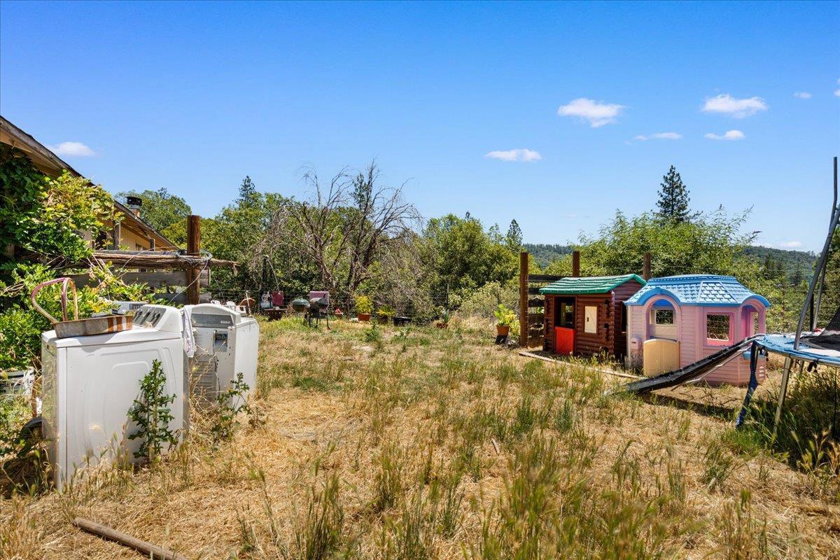10985 Tyler Foote Road Nevada City, CA 95959 - Photo 21 of 27 a view of a backyard with sitting area