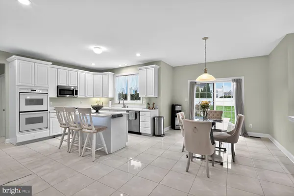 a view of a dining room kitchen and windows