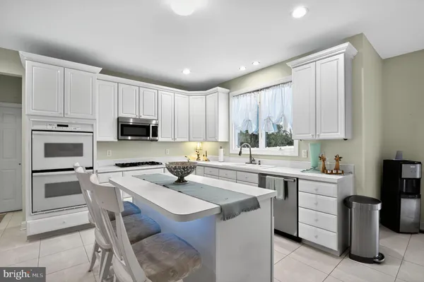 a kitchen with appliances cabinets and a sink