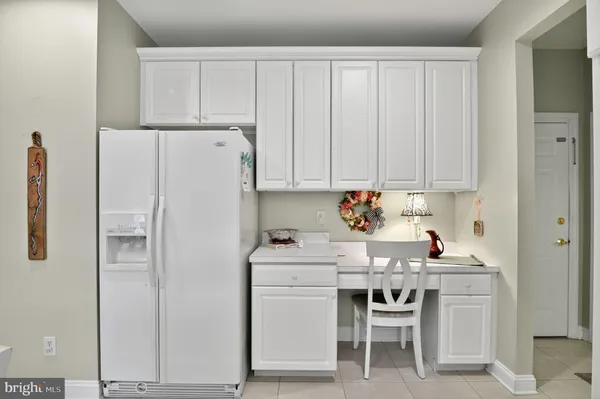 a white kitchen with sink and white appliances