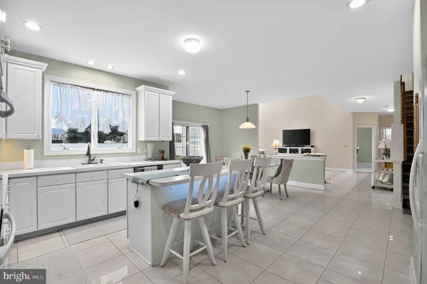 a large kitchen with a table and chairs