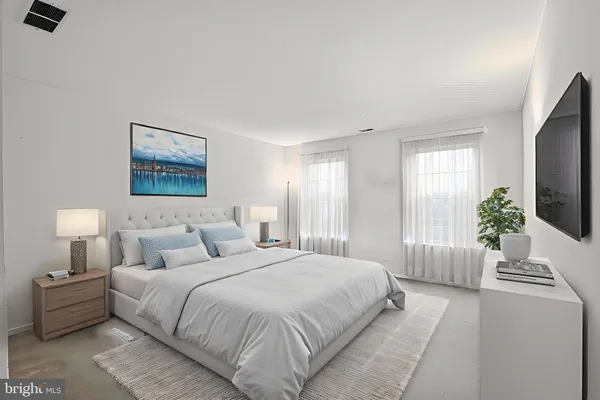 a spacious bedroom with a large bed and a flat screen tv