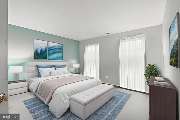 a bedroom with bed and a potted plant