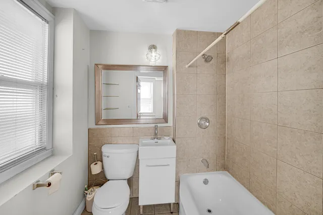 a bathroom with a toilet sink and shower
