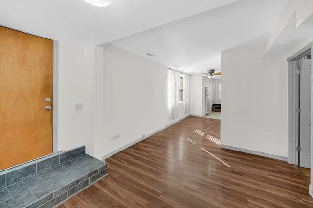 a view of wooden floor and windows in a room