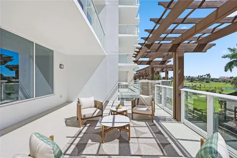 a view of a swimming pool with outdoor seating