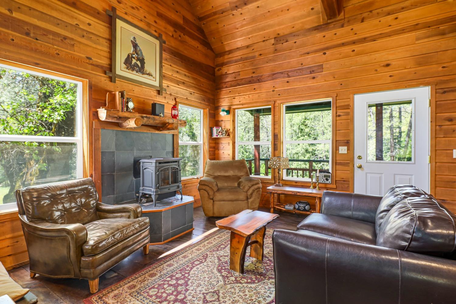 7744 Swiss Ranch Road Mountain Ranch, CA 95246 - Photo 19 of 64 a living room with fireplace furniture and a large window
