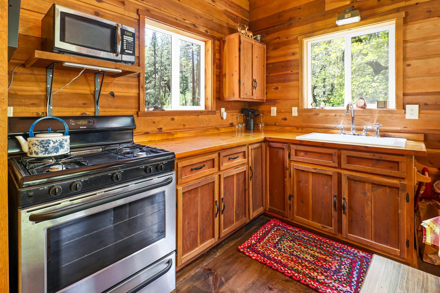 7744 Swiss Ranch Road Mountain Ranch, CA 95246 - Photo 23 of 64 a kitchen with stainless steel appliances granite countertop a stove and a sink