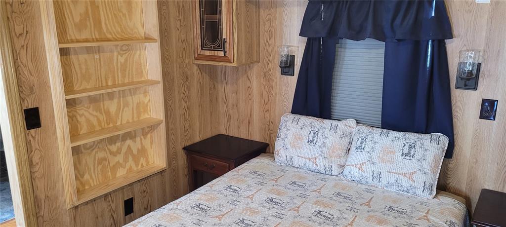 4421 Lane Road, Unit 216B Zephyrhills, FL 33541 - Photo 18 of 22 a bedroom with a bed and a dresser