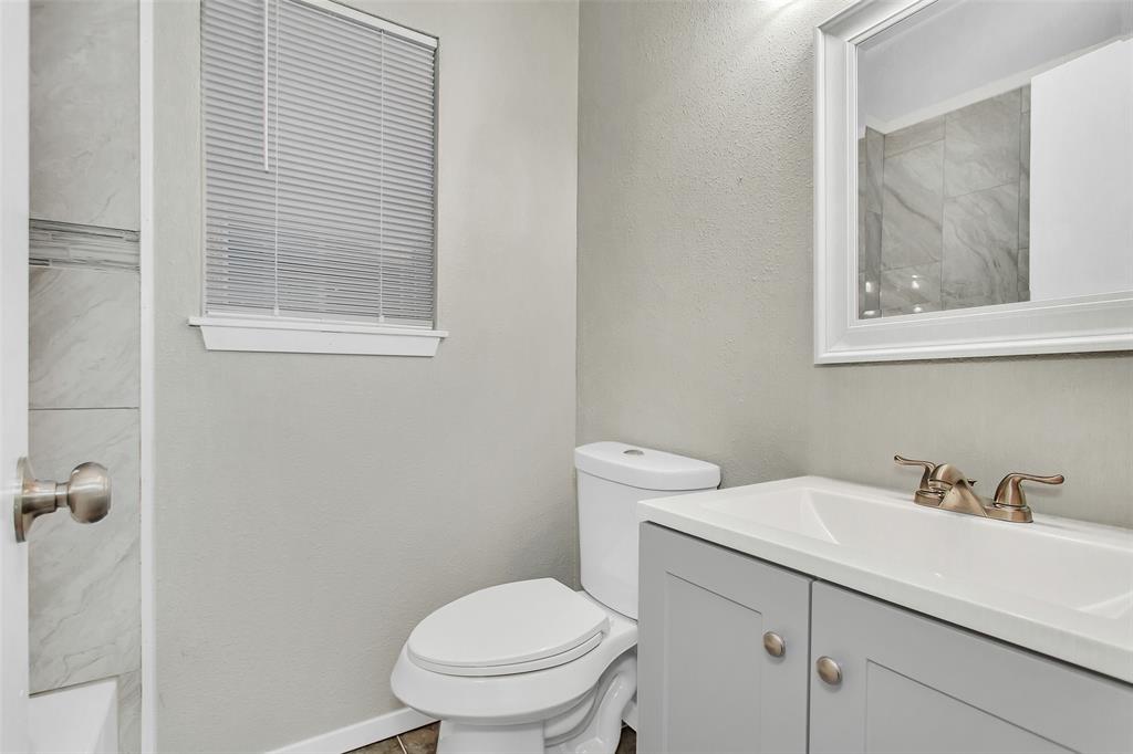 4916 Worth Street, Unit 1 Dallas, TX 75214 - Photo 15 of 27 a bathroom with a toilet sink and mirror