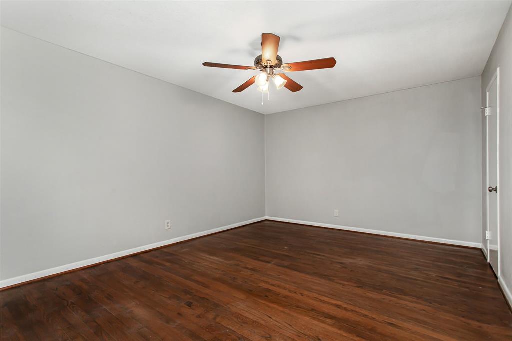 4916 Worth Street, Unit 1 Dallas, TX 75214 - Photo 16 of 27 an empty room with wooden floor and windows