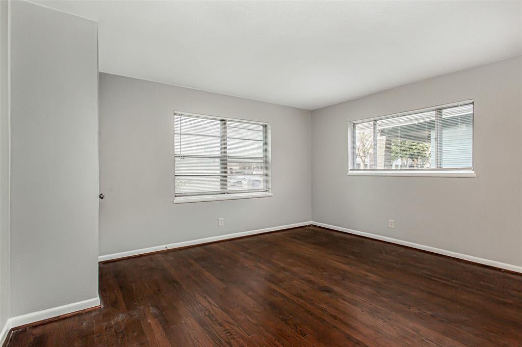 4916 Worth Street, Unit 1 Dallas, TX 75214 - Photo 2 of 27 a view of an empty room with wooden floor and a window