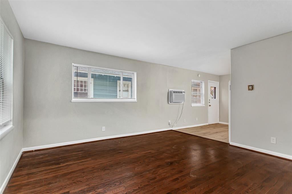 4916 Worth Street, Unit 1 Dallas, TX 75214 - Photo 3 of 27 a view of an empty room with wooden floor and a window