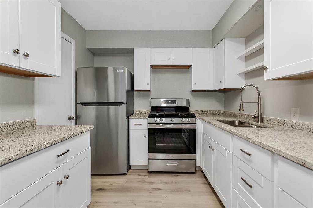 4916 Worth Street, Unit 1 Dallas, TX 75214 - Photo 4 of 27 a kitchen with stainless steel appliances granite countertop a sink stove and refrigerator