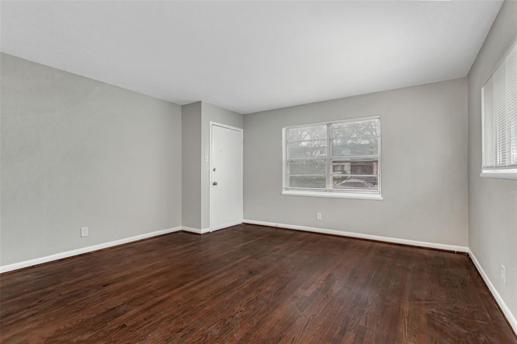 4916 Worth Street, Unit 1 Dallas, TX 75214 - Photo 6 of 27 a view of an empty room with wooden floor and a window