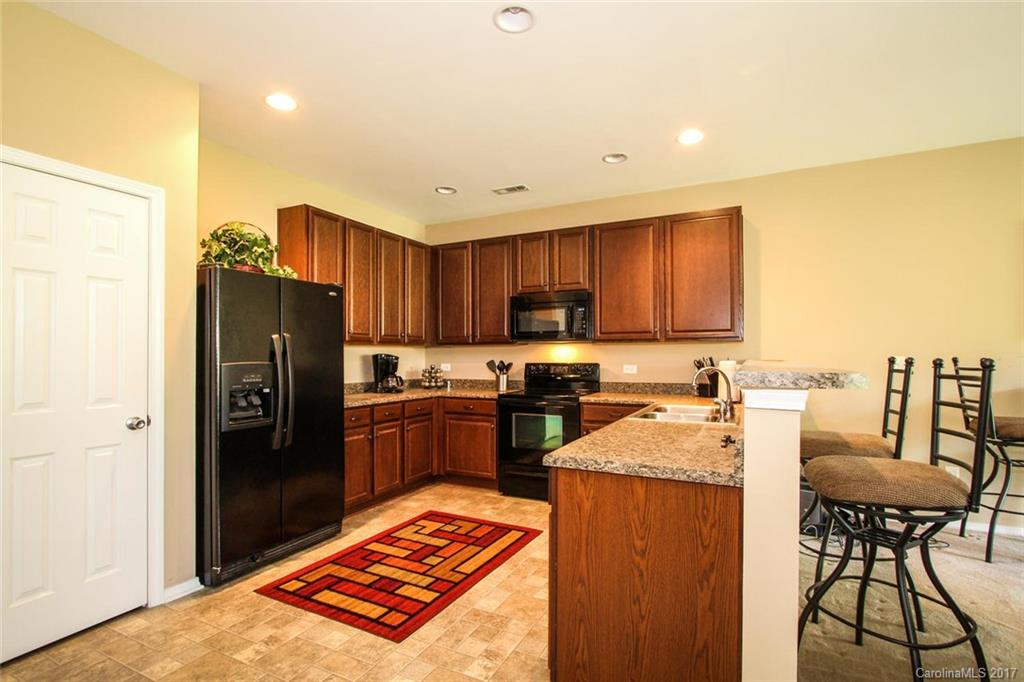 219 River Clay Road Fort Mill, SC 29708 - Photo 11 of 24 a kitchen with a refrigerator stove and a sink